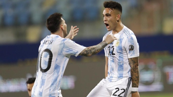 Argentinas Lautaro Martinez, right, celebrates with teammate Lionel Messi scoring his sides second goal against Ecuador during a Copa America quarterfinal soccer match at the Olimpico stadium in Goiania, Brazil, Saturday, July 3, 2021. (AP Photo/Andre Penner)