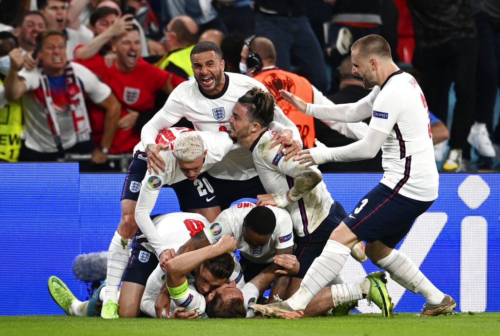 England's Harry Kane celebrates with teammates after scoring his sides second goal during the Euro 2020 soccer championship semifinal match between England and Denmark at Wembley Stadium in London, Wednesday, July 7, 2021. (Andy Rain/Pool via AP)