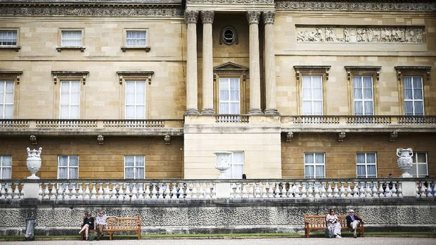 People sit together in The Garden of Buckingham Palace, during a preview day before it opens to the public, in London, Britain, July 8, 2021. REUTERS/Henry Nicholls