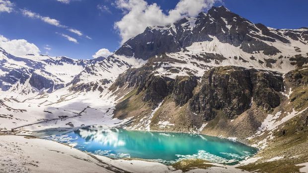 Parco Nazionale del Gran Paradiso Mountain road and Lake Agnel , snowcapped landscape – Gran Paradiso, Italy