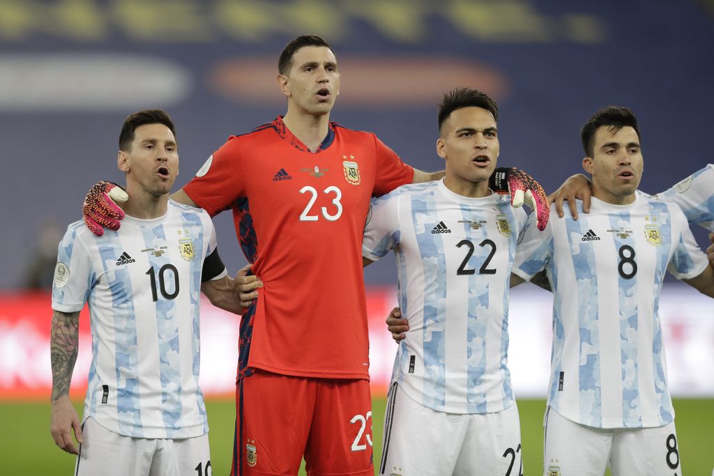 Argentina's players from left: Lionel Messi, goalkeeper Emiliano Martinez, Lautaro Martinez and Marcos Acuna sing their national anthem prior to the Copa America final soccer match against Brazil at the Maracana stadium in Rio de Janeiro, Brazil, Saturday, July 10, 2021. (AP Photo/Andre Penner)