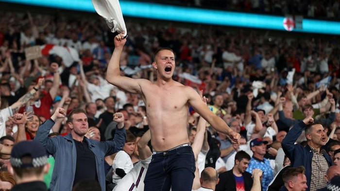 LONDON, ENGLAND - JULY 07: A fan of England celebrates their sides second goal scored by Harry Kane of England (not pictured) during the UEFA Euro 2020 Championship Semi-final match between England and Denmark at Wembley Stadium on July 07, 2021 in London, England. (Photo by Carl Recine - Pool/Getty Images)