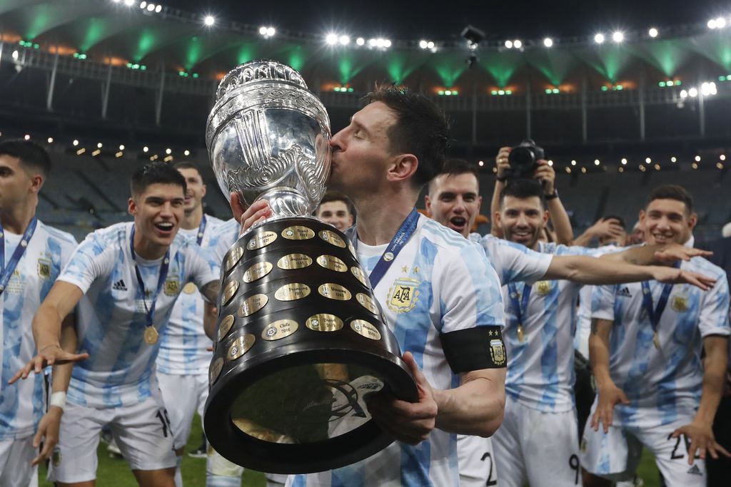 Argentina's Lionel Messi kisses the trophy after beating Brazil 1-0 in the Copa America final soccer match at Maracana stadium in Rio de Janeiro, Brazil, Saturday, July 10, 2021. (AP Photo/Bruna Pardo)