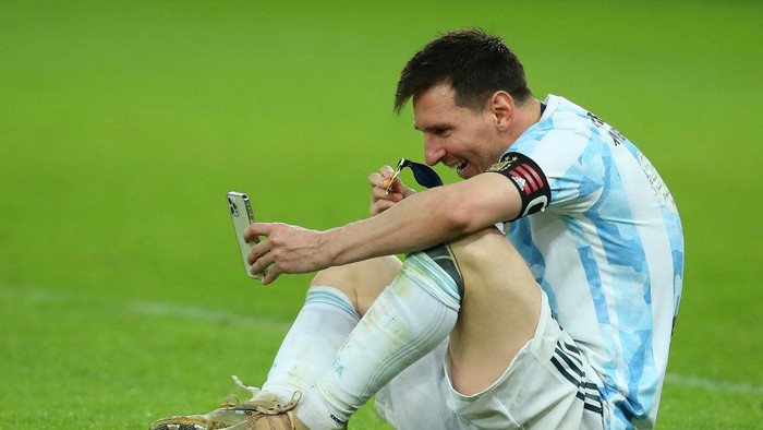 RIO DE JANEIRO, BRAZIL - JULY 10: Lionel Messi of Argentina celebrates as he talks on his phone with his family after winning the final of Copa America Brazil 2021 between Brazil and Argentina at Maracana Stadium on July 10, 2021 in Rio de Janeiro, Brazil. (Photo by Alexandre Schneider/Getty Images)