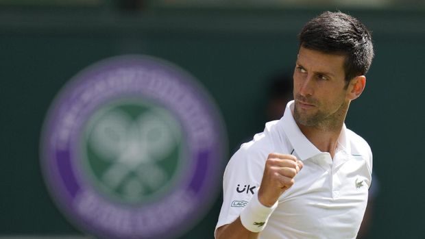 Serbia's Novak Djokovic celebrates after winning a point against Italy's Matteo Berrettini during the men's singles final on day thirteen of the Wimbledon Tennis Championships in London, Sunday, July 11, 2021. (AP Photo/Kirsty Wigglesworth)