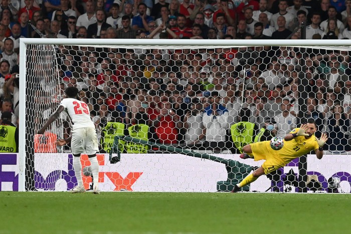 Gianluigi Donnarumma LONDON, ENGLAND - JULY 11: Bukayo Saka of England misses his team's fifth penalty in a penalty shoot out which is saved by Gianluigi Donnarumma of Italy during the penalty shoot out in the UEFA Euro 2020 Championship Final between Italy and England at Wembley Stadium on July 11, 2021 in London, England. (Photo by Paul Ellis - Pool/Getty Images)
