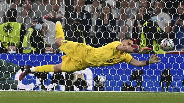 Italy's goalkeeper Gianluigi Donnarumma makes a save against England's Jadon Sancho during penalty shootout of the Euro 2020 soccer championship final match between England and Italy at Wembley Stadium in London, Sunday, July 11, 2021. (Paul Ellis/Pool via AP)