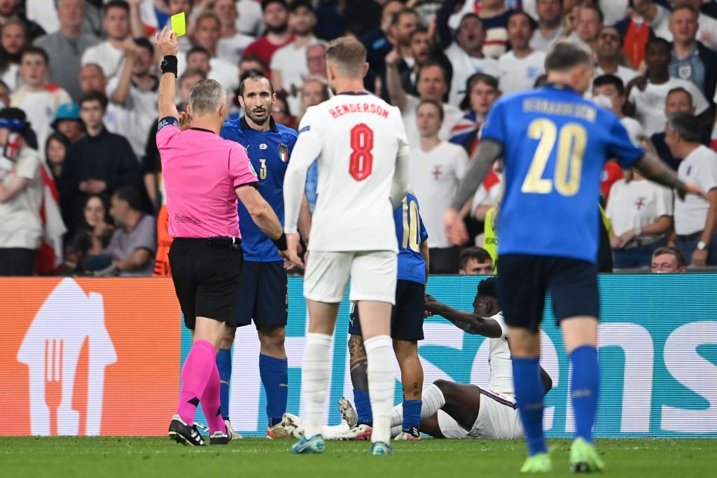 LONDON, ENGLAND - JULY 11: Bukayo Saka of England is fouled by Giorgio Chiellini of Italy during the UEFA Euro 2020 Championship Final between Italy and England at Wembley Stadium on July 11, 2021 in London, England. (Photo by Laurence Griffiths/Getty Images)