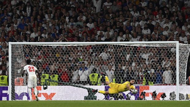 Italy's goalkeeper Gianluigi Donnarumma, right, makes a save against England's Bukayo Saka during penalty shootout of the Euro 2020 soccer championship final match between England and Italy at Wembley Stadium in London, Sunday, July 11, 2021. (Paul Ellis/Pool via AP)