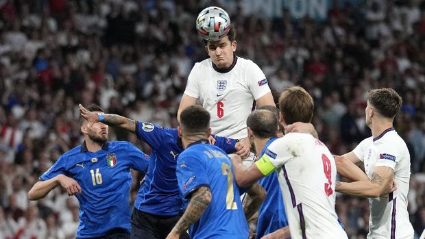 England's Harry Maguire heads the ball over Italy's defense during the Euro 2020 soccer championship final between England and Italy at Wembley stadium in London, Sunday, July 11, 2021. (AP Photo/Frank Augstein, Pool)