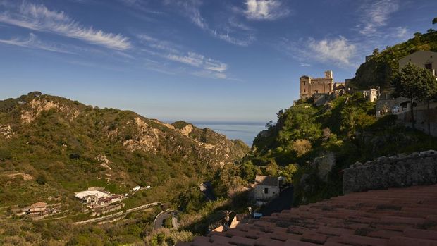 the Church of San Nicolò in the village of Savoca in Eastern Sicily and in the background the Ionian Sea