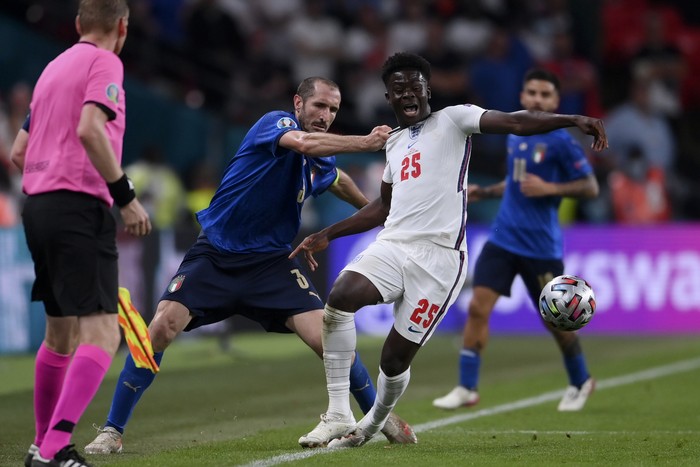 Giorgio Chiellini, Bukayo Saka Italy's Giorgio Chiellini, left, stops England's Bukayo Saka during the Euro 2020 soccer final match between England and Italy at Wembley stadium in London, Sunday, July 11, 2021. (Laurence Griffiths/Pool via AP)