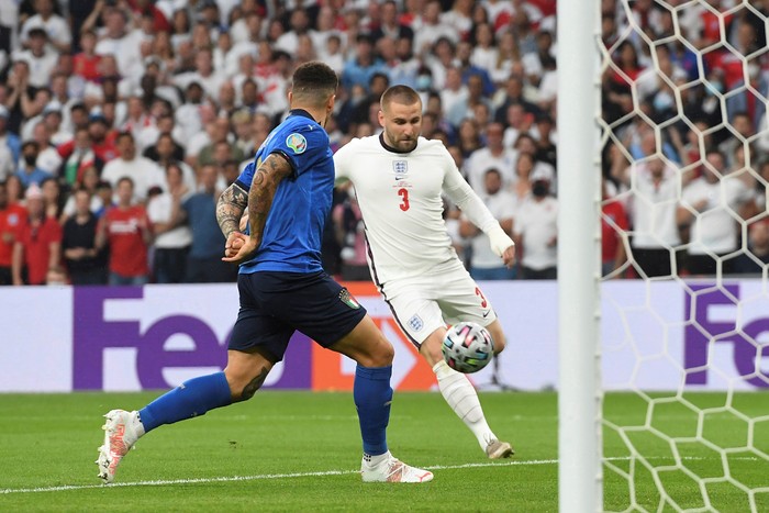 Englands Luke Shaw, right, scores his sides opening goal during the Euro 2020 soccer final match between England and Italy at Wembley stadium in London, Sunday, July 11, 2021. (Andy Rain/Pool Photo via AP)