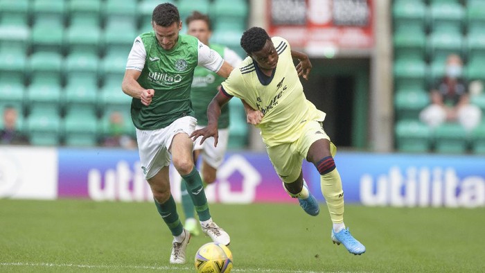 EDINBURGH, SCOTLAND - JULY 13: Paul McGinn of Hibernian tackles Eddie Nketiah of Arsenal during the pre season friendly between Hibernian and Arsenal at Easter Road on July 13, 2021 in Edinburgh, Scotland. (Photo by Steve  Welsh/Getty Images)