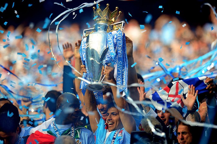 MANCHESTER, ENGLAND - MAY 13:  Scorer of the matchwinning goal Sergio Aguero of Manchester City celebrates with the trophy during the Barclays Premier League match between Manchester City and Queens Park Rangers at the Etihad Stadium on May 13, 2012 in Manchester, England.  (Photo by Shaun Botterill/Getty Images)