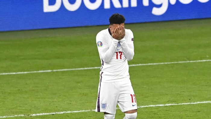 Englands Jadon Sancho reacts after missing a chance to score during the penalty shoot out of the Euro 2020 final soccer match between Italy and England at Wembley stadium in London, Sunday, July 11, 2021. (Facundo Arrizabalaga/Pool via AP)