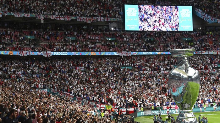 Fans cheer prior to the Euro 2020 final soccer match between Italy and England at Wembley stadium in London, Sunday, July 11, 2021. (Facundo Arrizabalaga/Pool via AP)