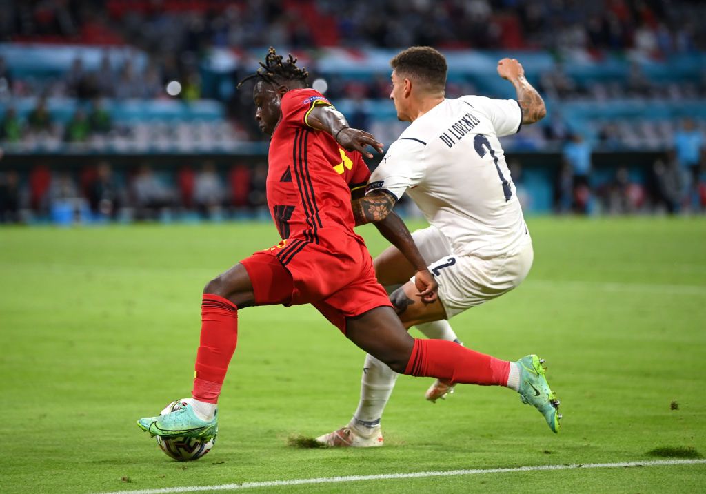 MUNICH, GERMANY - JULY 02: Jeremy Doku of Belgium is fouled by Giovanni Di Lorenzo of Italy leading to a penalty being awarded during the UEFA Euro 2020 Championship Quarter-final match between Belgium and Italy at Football Arena Munich on July 02, 2021 in Munich, Germany. (Photo by Matthias Hangst/Getty Images)