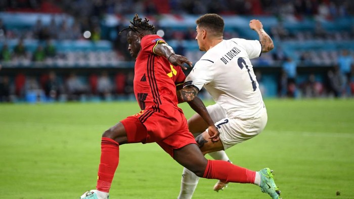 Jeremy Doku MUNICH, GERMANY - JULY 02: Jeremy Doku of Belgium is fouled by Giovanni Di Lorenzo of Italy leading to a penalty being awarded during the UEFA Euro 2020 Championship Quarter-final match between Belgium and Italy at Football Arena Munich on July 02, 2021 in Munich, Germany. (Photo by Matthias Hangst/Getty Images)