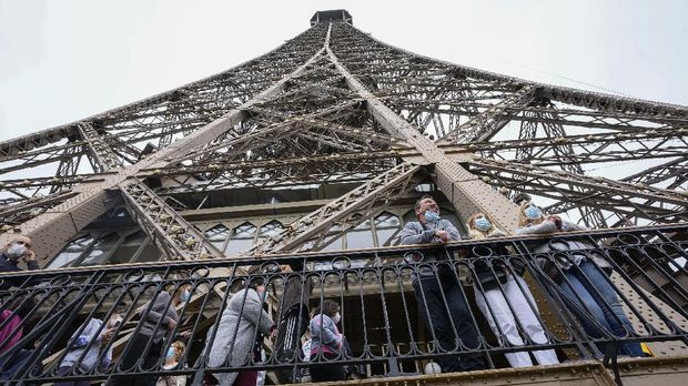 Visitors enjoy the view from the Eiffel Tower in Paris, Friday, July 16, 2021. The Eiffel Tower is reopening Friday for the first time in nine months, just as France faces new virus rules aimed at taming the fast-spreading delta variant. The 