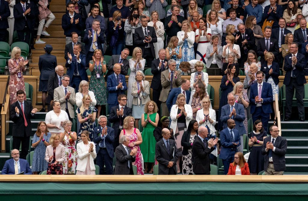 LONDON, ENGLAND - JUNE 28: The Royal Box stands and applauds University of Oxford Professor Sarah Gilbert (seated in red, bottom right) one of the people behind the Astra Zeneca COVID-19 vaccine ahead of the opening match on Centre Court during Day One of The Championships - Wimbledon 2021 at All England Lawn Tennis and Croquet Club on June 28, 2021 in London, England. (Photo by AELTC/Joe Toth-Pool/Getty Images)