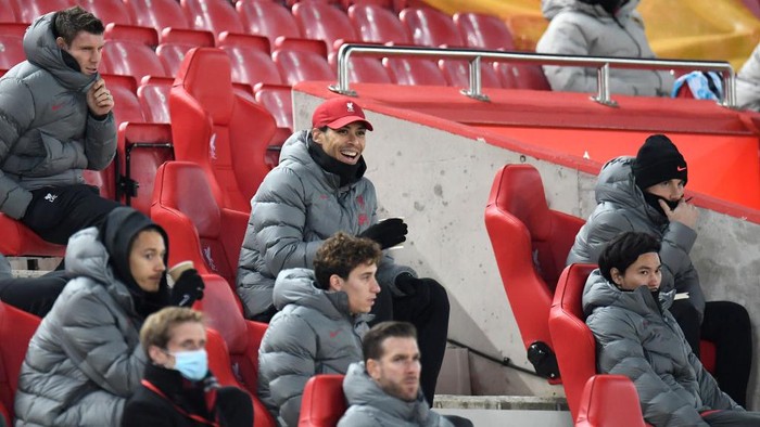 LIVERPOOL, ENGLAND - DECEMBER 06: Virgil van Dijk of Liverpool reacts as he sits in the stand during the Premier League match between Liverpool and Wolverhampton Wanderers at Anfield on December 06, 2020 in Liverpool, England. A limited number of fans (2000) are welcomed back to stadiums to watch elite football across England. This was following easing of restrictions on spectators in tiers one and two areas only. (Photo by Peter Powell - Pool/Getty Images)
