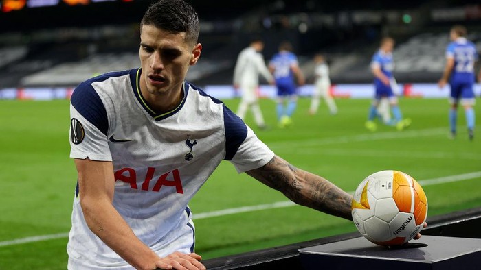 LONDON, ENGLAND - FEBRUARY 24: Erik Lamela of Tottenham Hotspur picks up a sanitised match ball before taking a corner kick during the UEFA Europa League Round of 32 match between Tottenham Hotspur and Wolfsberger AC at The Tottenham Hotspur Stadium on February 24, 2021 in London, England. Sporting stadiums around the UK remain under strict restrictions due to the Coronavirus Pandemic as Government social distancing laws prohibit fans inside venues resulting in games being played behind closed doors. (Photo by Julian Finney/Getty Images)