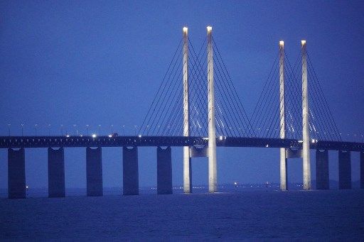 A picture taken on December 21, 2020 in Malmo, shows the Oresund Bridge, which connects Denmark and Sweden (Copenhagen and Malm). - Sweden announced on December 21, 2020 it was barring travellers from neigbouring Denmark starting December 22, 2020, after a new mutation of the coronavirus, first seen in the UK, had been reported in the country. (Photo by Johan NILSSON / TT News Agency / AFP) / Sweden OUT