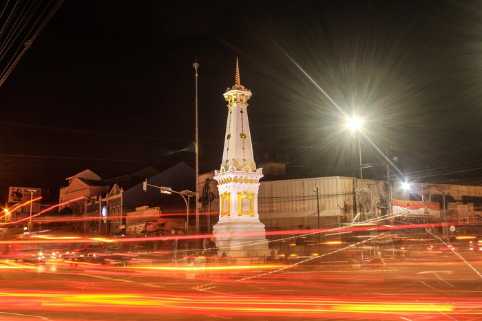 Tugu Jogja with slow shutter long exposure at night and fire light trail effect. This picture taken in Yogyakarya Indonesia. Tugu Jogja is a icon of Yogyakarya City.