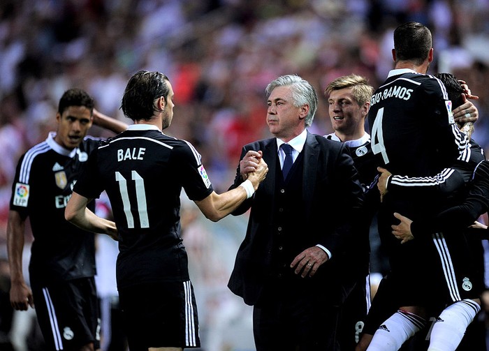 SEVILLE, SPAIN - MAY 02:  Head coach Carlo Ancelott of Real Madrid celebrates with Gareth Bale after Cristiano Ronaldo scored his teams 3rd goal during the La Liga match between Sevilla FC and Real Madrid CF at Estadio Ramon Sanchez Pizjuan on May 2, 2015 in Seville, Spain.  (Photo by Denis Doyle/Getty Images)