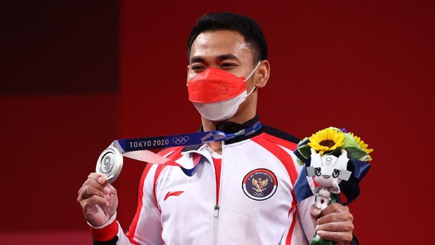 Tokyo 2020 Olympics - Weightlifting - Men's 61kg - Medal Ceremony - Tokyo International Forum, Tokyo, Japan - July 25, 2021. Silver medalist Eko Yuli Irawan of Indonesia reacts. REUTERS/Edgard Garrido