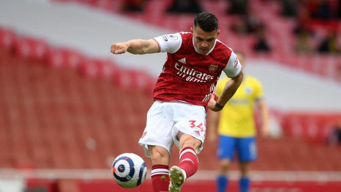LONDON, ENGLAND - MAY 23: Granit Xhaka of Arsenal takes a shot during the Premier League match between Arsenal and Brighton & Hove Albion at Emirates Stadium on May 23, 2021 in London, England. A limited number of fans will be allowed into Premier League stadiums as Coronavirus restrictions begin to ease in the UK. (Photo by Mike Hewitt/Getty Images)