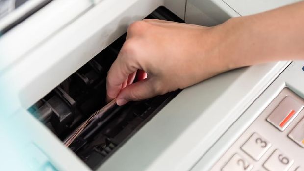 lady's hand pressing ATM pin for cash withdrawal