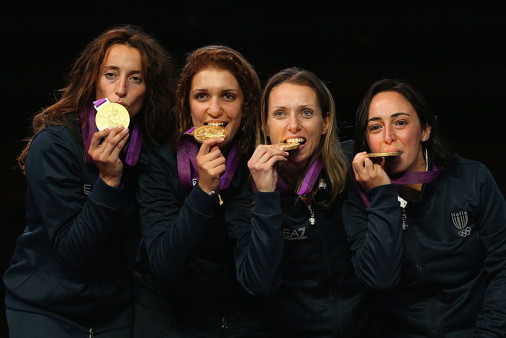 LONDON, ENGLAND - AUGUST 02:  Ilaria Salvatori, Arianna Errigo, Valentina Vezzali and Elisa Di Francisca of Italy celebrate with their gold medals during the medal ceremony after the Women's Foil Team Fencing gold medal match on Day 6 of the London 2012 Olympic Games at ExCeL on August 2, 2012 in London, England. Russia won silver and Korea won bronze.  (Photo by Hannah Peters/Getty Images)