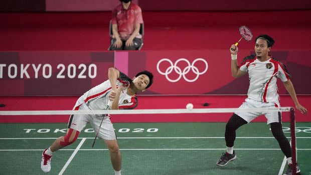 Indonesia's Hendra Setiawan and Mohammad Ahsan play against South Korea's Choi Sol-gyu and Seo Sung-jae during their men's doubles group play stage badminton match at the 2020 Summer Olympics, Tuesday, July 27, 2021, in Tokyo, Japan. (AP Photo/Dita Alangkara)