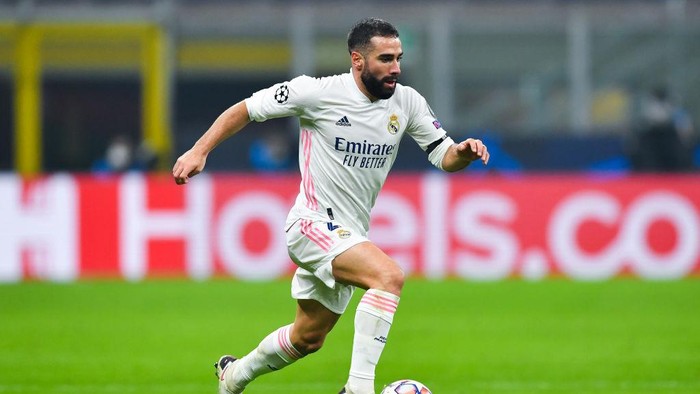 MILAN, ITALY - NOVEMBER 25: Daniel Carvajal of Real Madrid runs with the ball during the UEFA Champions League Group B stage match between FC Internazionale and Real Madrid at Stadio Giuseppe Meazza on November 25, 2020 in Milan, Italy. Football Stadiums around Europe remain empty due to the Coronavirus Pandemic as Government social distancing laws prohibit fans inside venues resulting in fixtures being played behind closed doors. (Photo by Valerio Pennicino/Getty Images)