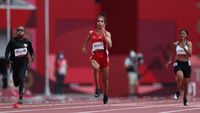 TOKYO, JAPAN - JULY 30: Mazoon Al Alawi of Team Oman and Alvin Tehupeiory of Team Indonesia competes in the Womens 100 metres Preliminary Round heats on day seven of the Tokyo 2020 Olympic Games at Olympic Stadium on July 30, 2021 in Tokyo, Japan. (Photo by Christian Petersen/Getty Images)\