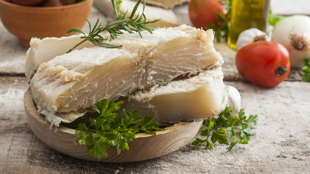 salted codfish on the wooden table with ingredients