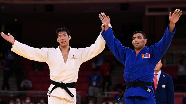 Tokyo 2020 Olympics - Judo - Men's 81kg - Gold medal match - Nippon Budokan - Tokyo, Japan - July 27, 2021. Takanori Nagase of Japan celebrates with Saeid Mollaei of Mongolia after the match REUTERS/Annegret Hilse