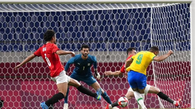 Brazil's Matheus Cunha, 9, scores the opening goal against Egypt during a men's quarterfinal soccer match at the 2020 Summer Olympics, Saturday, July 31, 2021, in Saitama, Japan. (AP Photo/Silvia Izquierdo)