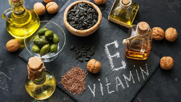 Food rich in vitamin E. A set of different oils. Seeds of flax, sunflower, walnut, olives. Top view