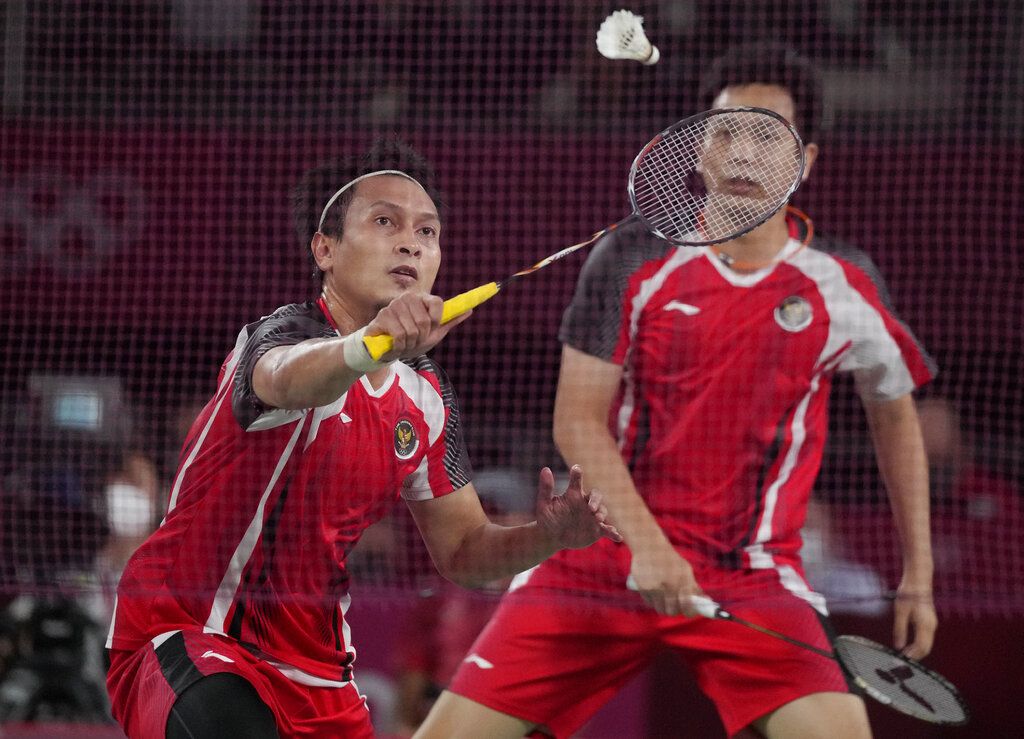 Malaysia's Malaysia's Aaron Chia, left, and Soh Wooi Yik celebrate after winning against Indonesia's Mohammad Ahsan and Hendra Setiawan during their badminton men's doubles bronze medal match at the 2020 Summer Olympics, Saturday, July 31, 2021, in Tokyo, Japan. (AP Photo/Dita Alangkara)