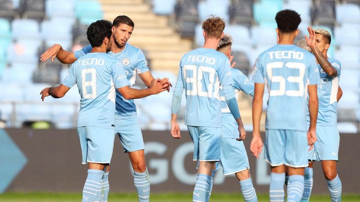 MANCHESTER, ENGLAND - AUGUST 03: Ilkay Gundogan of Manchester City celebrates with Ruben Dias after scoring their sides third goal during the Pre-Season Friendly match between Manchester City and Blackpool at Manchester City Football Academy on August 03, 2021 in Manchester, England. (Photo by Lewis Storey/Getty Images)