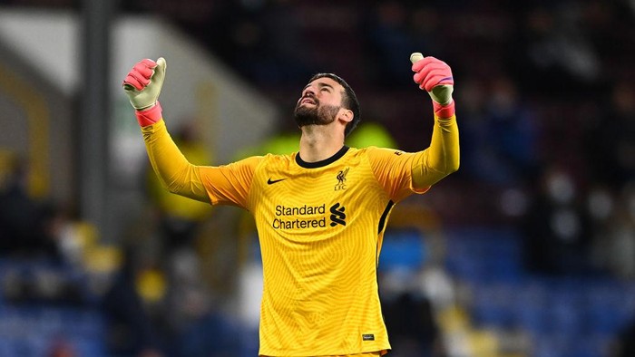 BURNLEY, ENGLAND - MAY 19: Alisson of Liverpool celebrates after their sides third goal scored by Alex Oxlade-Chamberlain (Not pictured) during the Premier League match between Burnley and Liverpool at Turf Moor on May 19, 2021 in Burnley, England. A limited number of fans will be allowed into Premier League stadiums as Coronavirus restrictions begin to ease in the UK. (Photo by Clive Mason/Getty Images)