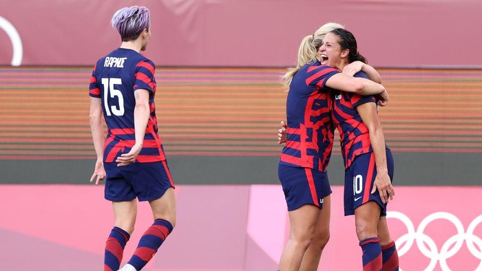 KASHIMA, JAPAN - AUGUST 05: Carli Lloyd #10 of Team United States celebrates with Lindsey Horan #9 after scoring their sides third goal during the Womens Bronze Medal match between United States and Australia on day thirteen of the Tokyo 2020 Olympic Games at Kashima Stadium on August 05, 2021 in Kashima, Japan. (Photo by Elsa/Getty Images)