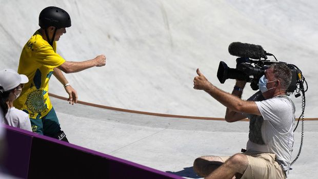 Kieran Woolley of Australia crashes in to a cameraman during the men's park skateboarding prelims at the 2020 Summer Olympics, Thursday, Aug. 5, 2021, in Tokyo, Japan. (AP Photo/Ben Curtis)