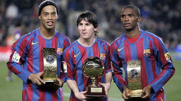 FILE - In this Dec. 20, 2005 file photo Barcelona's Brazilian soccer player Ronaldinho, left, and Samuel Eto'o, from Cameroon, right, show their FIFA world player trophies and Argentinean Leo Messi, center, with his Golden Boy Trophy before their Spanish League soccer match against Celta Vigo at Nou Camp Stadium in Barcelona, Spain. Lionel Messi's time at Barcelona appears to be over. Barcelona announced Thursday Aug. 5, 2021 that Lionel Messi will not stay with the club. He is leaving after 17 successful seasons in which he propelled the Catalan club to glory, helping it win numerous domestic and international titles since debuting as a teenager.(AP Photo/Manu Fernandez, File)
