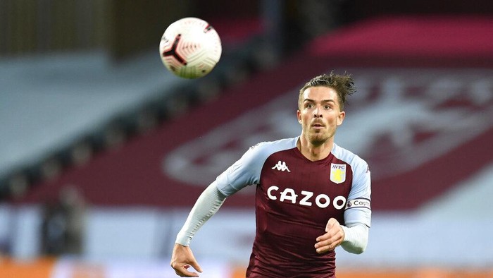 FILE - In this Sunday, Oct, 4, 2020 file photo, Aston Villas Jack Grealish goes for the ball during the English Premier League soccer match between Aston Villa and Liverpool at the Villa Park stadium in Birmingham, England. Premier League champion Manchester City has broken the British transfer record to sign midfielder Jack Grealish from Aston Villa. City reportedly paid a transfer fee of 100 million pounds ($139 million) — the most ever by a Premier League club. The 25-year-old Grealish signed a six-year contract. The previous record fee was the 105 million euros ($124 million) that Manchester United paid Juventus for midfielder Paul Pogba in 2016. (Peter Powell/Pool via AP, File)