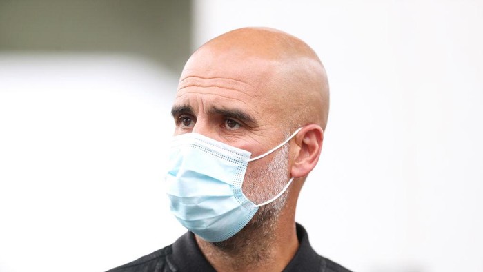 MANCHESTER, ENGLAND - JULY 31: Pep Guardiola, Manager of Manchester City is seen wearing a face mask as he arrives at the stadium prior to the Pre-Season Friendly match between Manchester City and Barnsley at Manchester City Football Academy on July 31, 2021 in Manchester, England. (Photo by Lewis Storey/Getty Images)