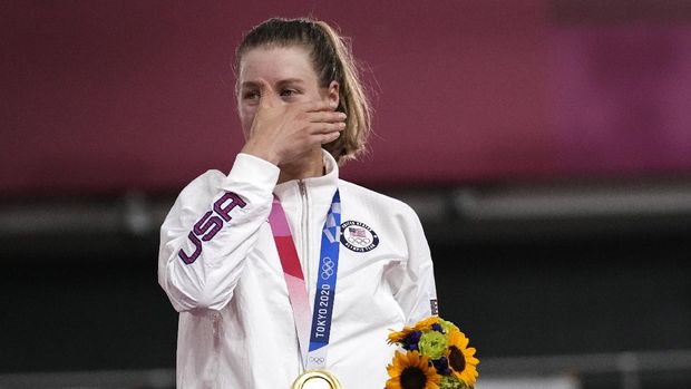Gold medalist Jennifer Valente of Team United States reacts during medal ceremony for the track cycling women's omnium points race at the 2020 Summer Olympics, Sunday, Aug. 8, 2021, in Izu, Japan. (AP Photo/Christophe Ena)